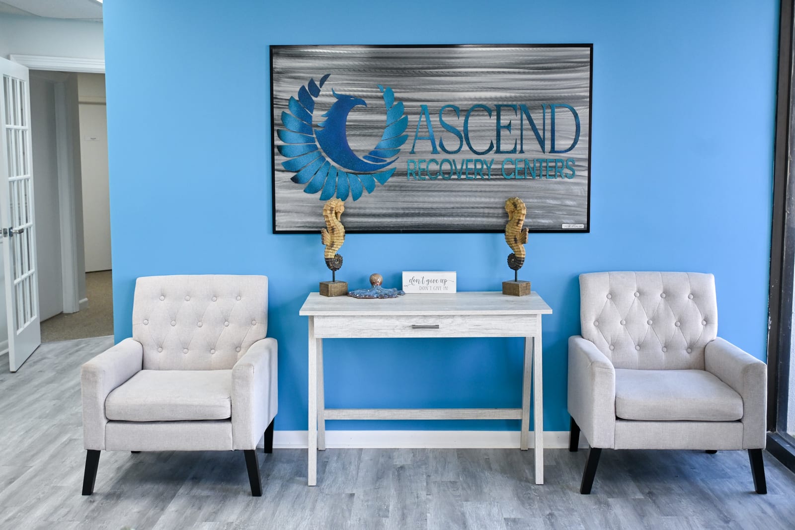 Ascend Recovery Center branded lobby sign and seating area in Palm Beach Gardens, Florida